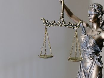 Justitia Bronzefigur mit verbundenen Augen und Waage in der Hand