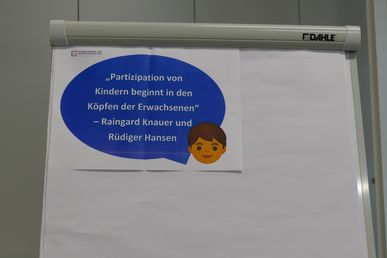 An einer Pinnwand klebt eine Sprechblase mit Zitat von Rüdiger Hansen: Partizipation von Kindern beginnt in den Köpfen der Erwachsenen."